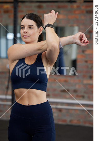 Fitness, exercise or woman stretching at gym for flexible arms in body warm up exercise, training or workout. Wellness, relax or healthy girl athlete exercising for body goals, sports or self care 127340058