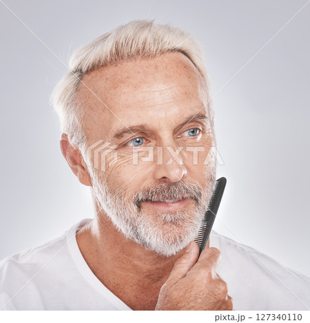Beard comb, mature man and face on studio background for growth maintenance, barber cleaning and healthy skincare. Male model, facial and brushing hair care for beauty, aesthetic fashion or cosmetics Beard comb, mature man and face on studio background for growth maintenance, barber cleaning and healthy skincare. Male model, facial and brushing hair care for beauty, aesthetic fashion or cosmetics 127340110
