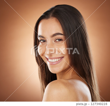 Hair, beauty and portrait of woman in studio for wellness, hair treatment and shampoo products. Hair salon, hair care aesthetic and girl face with healthy, natural and long hair on brown background Hair, beauty and portrait of woman in studio for wellness, hair treatment and shampoo products. Hair salon, hair care aesthetic and girl face with healthy, natural and long hair on brown background 127340228