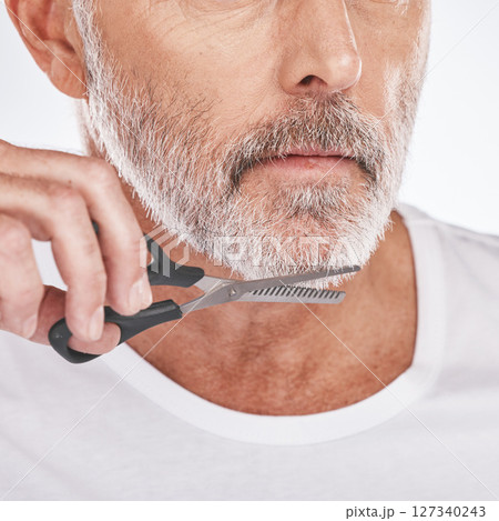 Trim, beard and senior man with scissors for grooming, facial cleaning and morning routine on a studio background. Barber, care and face of a senior model trimming hair for a clean beauty look Trim, beard and senior man with scissors for grooming, facial cleaning and morning routine on a studio background. Barber, care and face of a senior model trimming hair for a clean beauty look 127340243