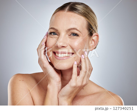 Woman, skincare glow or hands to face on grey studio background for Canada dermatology, healthcare wellness or self care grooming. Portrait, smile or happy beauty model with facial makeup cosmetics Woman, skincare glow or hands to face on grey studio background for Canada dermatology, healthcare wellness or self care grooming. Portrait, smile or happy beauty model with facial makeup cosmetics 127340251