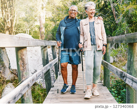 Relax, senior or couple of friends hiking, walking or trekking for freedom, exercise or fitness in nature forest. Interracial, travel or happy woman enjoys bonding time with healthy elderly partner 127340368