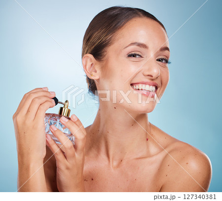 Perfume, portrait or woman in studio with a happy smile grooming or relaxing with a fragrance sprayer. Mockup space, advertising or beautiful girl model with marketing a perfume bottle for self care 127340381