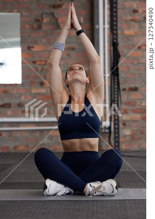 Fitness, yoga or woman stretching in gym for balance, flexible spine or warm up body with healthy breathing. Floor, breathe or zen girl in training, exercise or workout with focus or flexibility 127340490