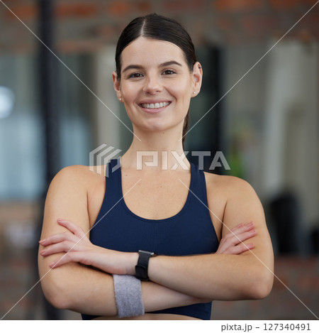Woman in gym, portrait and exercise with smile for fitness, health and cardio with active lifestyle, happy and strong. Focus, wellness and sport motivation with young female athlete and body training 127340491