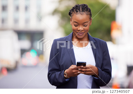Black woman, phone and app communication on travel commute with online networking and social media check. Corporate worker on mobile internet break reading news with happy smile in urban town. Black woman, phone and app communication on travel commute with online networking and social media check. Corporate worker on mobile internet break reading news with happy smile in urban town. 127340507