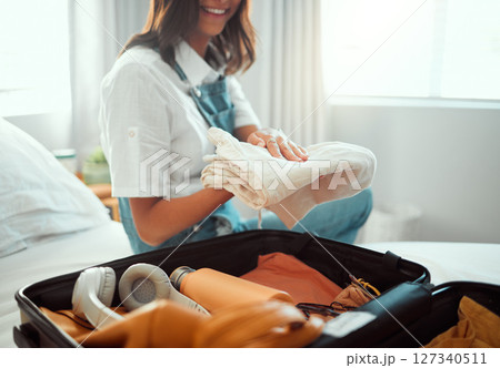Woman packing clothes in suitcase, luggage and bag for travel adventure, vacation and international journey, holiday and tourism. Closeup female tourist, hotel room and planning baggage for clothing 127340511