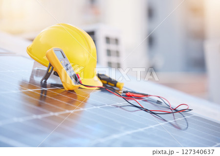 Tools, solar panels or helmet on roof for solar energy installation in a city development project. Voltmeter, Construction, renewable energy or electric engineering equipment for building maintenance Tools, solar panels or helmet on roof for solar energy installation in a city development project. Voltmeter, Construction, renewable energy or electric engineering equipment for building maintenance 127340637