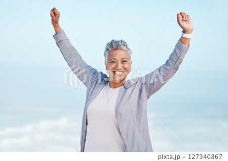 Fitness, hands in air and senior woman for exercise, fitness or workout portrait goals, success and achievement on blue sky mockup. Winner, freedom and healthy celebration of elderly runner in nature Fitness, hands in air and senior woman for exercise, fitness or workout portrait goals, success and achievement on blue sky mockup. Winner, freedom and healthy celebration of elderly runner in nature 127340867