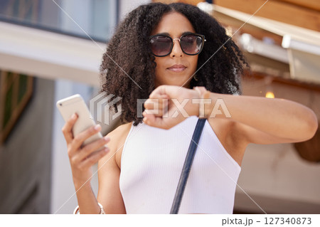 Time, watch and smartphone of woman in city for summer shopping sale, discount or promotion marketing with online website. Black woman outdoor on cellphone waiting for promo on retail, ecommerce app Time, watch and smartphone of woman in city for summer shopping sale, discount or promotion marketing with online website. Black woman outdoor on cellphone waiting for promo on retail, ecommerce app 127340873