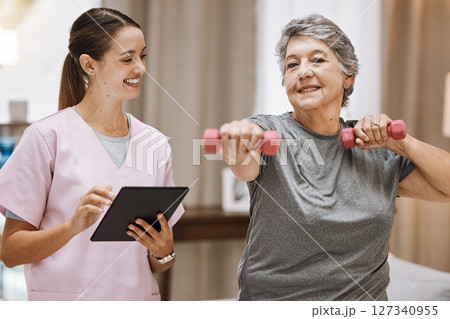 Nurse with tablet, old woman in nursing home and physical therapy fitness with dumbbell, healthcare and digital checklist for wellness. Health, retirement care and exercise with muscle training. Nurse with tablet, old woman in nursing home and physical therapy fitness with dumbbell, healthcare and digital checklist for wellness. Health, retirement care and exercise with muscle training. 127340955