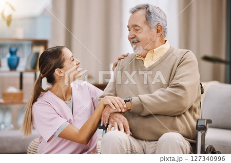 Healthcare, disability and man in wheelchair with nurse in retirement or nursing home with smile on face. Senior care, happy disabled grandpa and woman caregiver in living room at home in Mexico 127340996