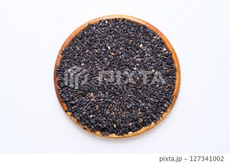 Black sesame seed in wooden bowl on white background, Food ingredient, Top view Black sesame seed in wooden bowl on white background, Food ingredient, Top view 127341002