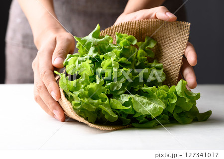 Organic green oak lettuce wrapped with burlap fabric by hand, Eco friendly package 127341017