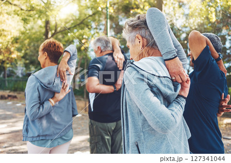 Fitness, nature and senior people doing stretching exercise before cardio training in a park. Health, wellness and active group of elderly friends in retirement doing arm warm up for outdoor workout. Fitness, nature and senior people doing stretching exercise before cardio training in a park. Health, wellness and active group of elderly friends in retirement doing arm warm up for outdoor workout. 127341044