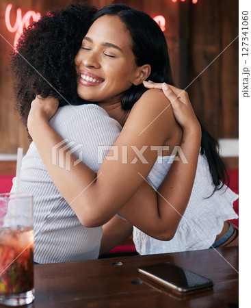 Happy, support and friends hug at restaurant for bond, care and reunion hangout in Chicago, USA. Happiness, smile and embrace of black people in friendship enjoying friendly greeting at diner. Happy, support and friends hug at restaurant for bond, care and reunion hangout in Chicago, USA. Happiness, smile and embrace of black people in friendship enjoying friendly greeting at diner. 127341060