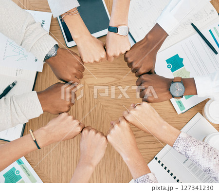 Diversity, fist hands and teamwork with documents on table for marketing business meeting, creative collaboration and goals support motivation. Team, circle hand and planning strategy or logistics Diversity, fist hands and teamwork with documents on table for marketing business meeting, creative collaboration and goals support motivation. Team, circle hand and planning strategy or logistics 127341230