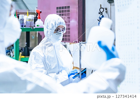 防護服を着て作業する作業員グループ 127341414