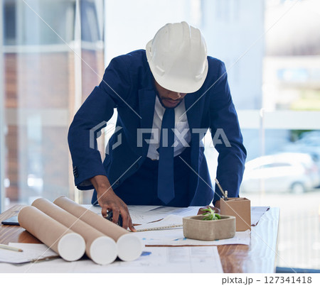 Architect, blueprint and planning, architecture and black man working in office, corporate construction job. Review building plan, design and drawing on desk with construction worker and businessman. 127341418