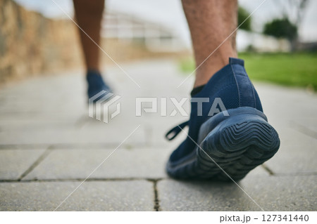 Running shoes, exercise and fitness with feet of a man outdoor on a pavement for a cardio workout. Athlete runner with sneakers for sports training for health, wellness and a healthy lifestyle Running shoes, exercise and fitness with feet of a man outdoor on a pavement for a cardio workout. Athlete runner with sneakers for sports training for health, wellness and a healthy lifestyle 127341440