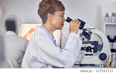 Science, laboratory and black woman with microscope, research for vaccine development. Healthcare, medical innovation and senior scientist woman in hospital lab looking at pharmaceutical test results Science, laboratory and black woman with microscope, research for vaccine development. Healthcare, medical innovation and senior scientist woman in hospital lab looking at pharmaceutical test results 127341511