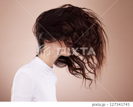 Beauty, salon and woman with hair movement for hair care, shampoo products and keratin treatment in studio. Fashion, cosmetics and girl pose for wellness, healthy hairstyle and hair salon aesthetic 127341745