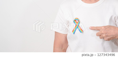 Elderly with LGBTQ Rainbow ribbon for concept of June Pride month, April Autism Awareness, All cancer Awareness, February World Cancer day, October World Hospice and Palliative care day and Survivor Elderly with LGBTQ Rainbow ribbon for concept of June Pride month, April Autism Awareness, All cancer Awareness, February World Cancer day, October World Hospice and Palliative care day and Survivor 127343496