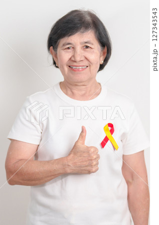 World hepatitis day awareness month, 28 July. elderly woman with Red and Yellow ribbon. Liver cancer, Jaundice, Cirrhosis, Failure, Enlarged, Hepatic Encephalopathy and Health concept World hepatitis day awareness month, 28 July. elderly woman with Red and Yellow ribbon. Liver cancer, Jaundice, Cirrhosis, Failure, Enlarged, Hepatic Encephalopathy and Health concept 127343543