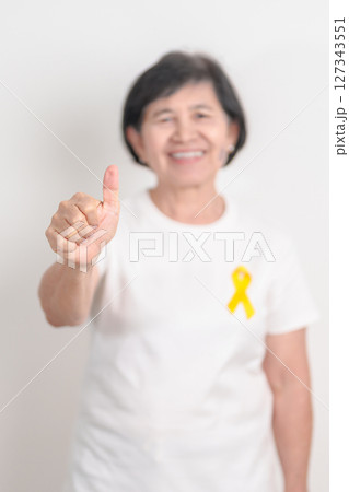 Elderly with Yellow Ribbon for concept of yellow September, Suicide prevention day, Childhood, July Sarcoma, bone cancer Awareness in children month, support survivor. Healthcare and World Cancer day Elderly with Yellow Ribbon for concept of yellow September, Suicide prevention day, Childhood, July Sarcoma, bone cancer Awareness in children month, support survivor. Healthcare and World Cancer day 127343551