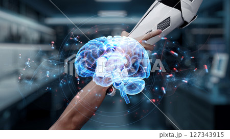 Close up of hand reaching and holding robotic arm with brain icon. Salubrious. Close up of hand reaching and holding robotic arm with brain icon. Salubrious. 127343915