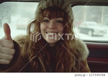 Happy Woman in Fur-Trimmed Coat Gives Thumbs Up from Car 127344788