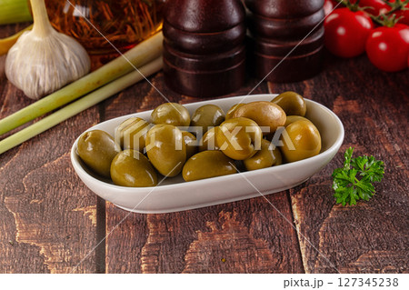 Greek green olives marinated in the bowl 127345238