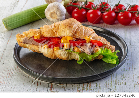 Croissant with tuna, tomato and salad Croissant with tuna, tomato and salad 127345240