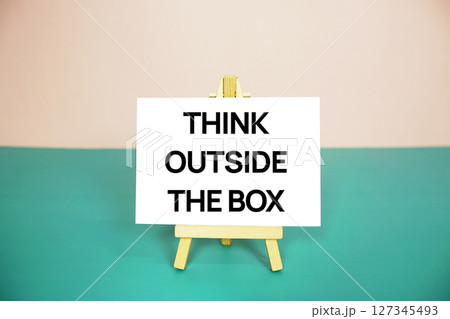 Think outside the box text message on paper card with wooden easel stand Think outside the box text message on paper card with wooden easel stand 127345493