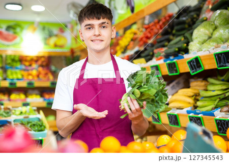 Grocery store clerk offers to buy basil Grocery store clerk offers to buy basil 127345543