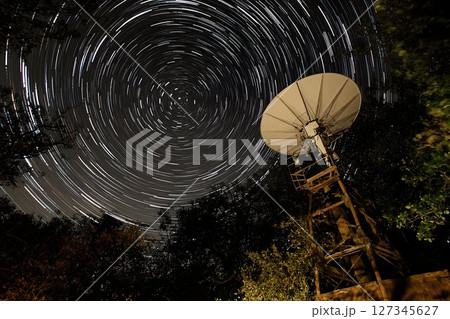 Satellite Dish Under Star Trails at Night 127345627