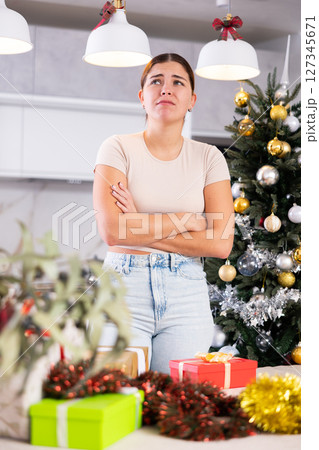 upset girl in a festive New Year s atmosphere upset girl in a festive New Year s atmosphere 127345671