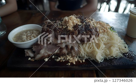 Grilled Pork and Noodles with Peanut Topping on a Wooden Board 127346026