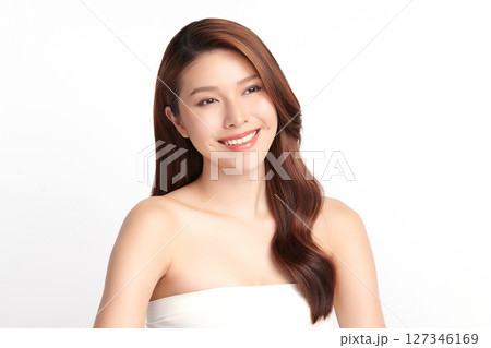 A beautiful young Asian woman with clean, fresh skin against a white background. Skincare, facial treatment, cosmetology, beauty, and spa. An elegant portrait of an Asian woman. 127346169
