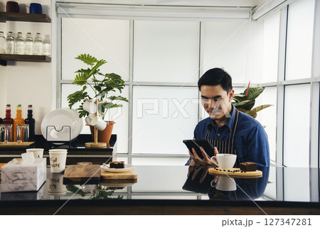 Coffee barista man make espresso shot from coffee maker hot cup. Cappuccino with milk in italian coffee shop cafe. Close up hands of barista use machine make brown latte art for customer cafeteria Coffee barista man make espresso shot from coffee maker hot cup. Cappuccino with milk in italian coffee shop cafe. Close up hands of barista use machine make brown latte art for customer cafeteria 127347281