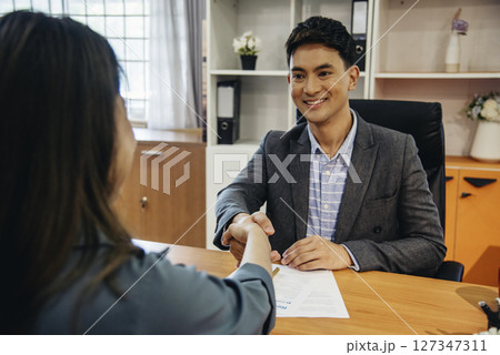 Job HR applicants having an interview with Human resource manager jobs interviewing with confident candidate at business firm office give cv resume. Job Interview with headhunter agent and applicant 127347311
