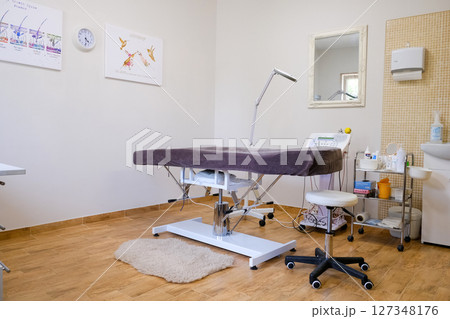 Medical equipment for electrolysis, cosmetology, epilation couch. Beauty salon interior details 127348176
