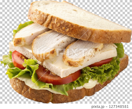 A classic sliced chicken sandwich with fresh lettuce juicy tomato and savory grilled chicken between slices of soft white bread 127348581