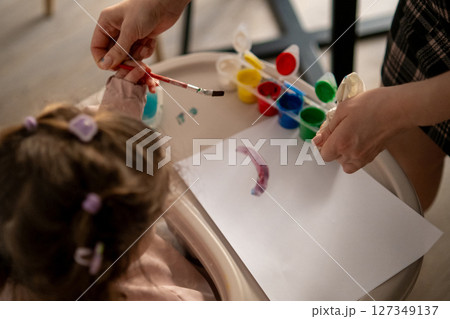 Mother teaches young girl to paint with gouache Mother teaches young girl to paint with gouache 127349137
