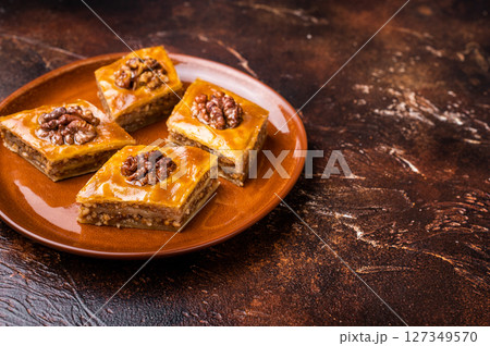 Delicious Honey Walnut Baklava on plate. brown background. top view 127349570