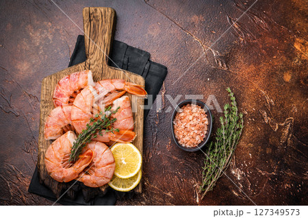 Fresh raw Headless Red Argentine shrimps, Prawns on wooden board. brown background. top view 127349573