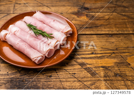 Italian Sliced Prosciutto Cotto ham on plate. wooden background. top view Italian Sliced Prosciutto Cotto ham on plate. wooden background. top view 127349578