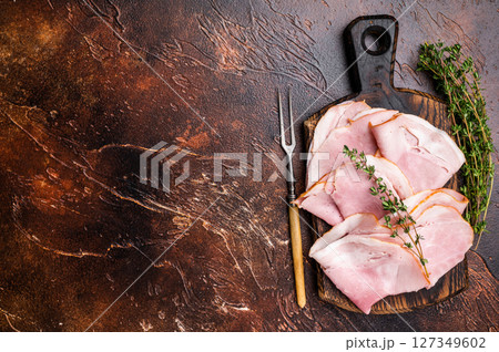 Ham Prosciutto Cotto, Sliced Pork Ham on wooden board. brown background. top view Ham Prosciutto Cotto, Sliced Pork Ham on wooden board. brown background. top view 127349602