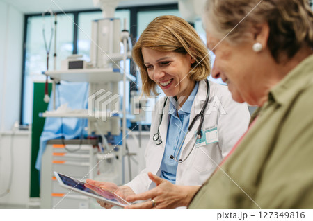 Geriatrician talking about test results with senior patient during check-up. 127349816