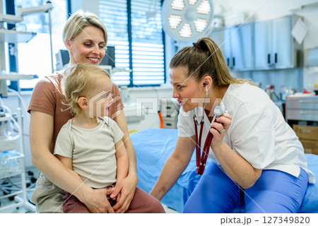 Doctor listening little boy's heartbeat and breathing during preventive medical checkup. 127349820